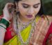 Close-up of a woman in traditional Indian bridal attire with elaborate jewelry.